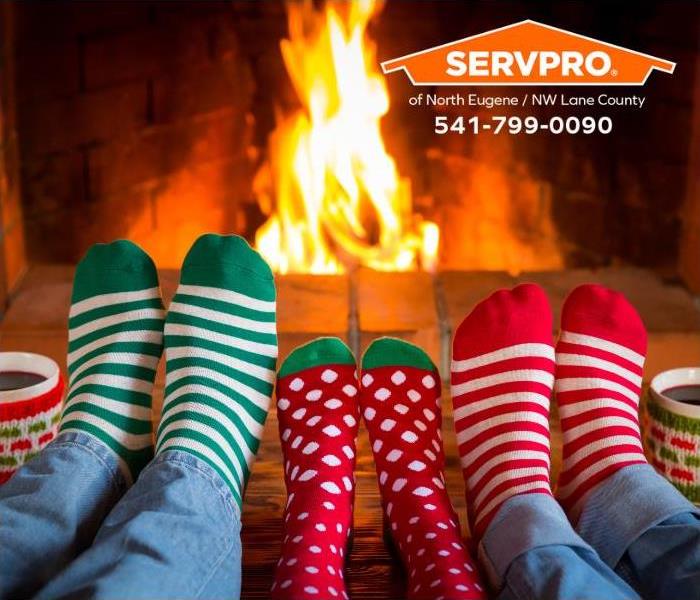 A family enjoys a brightly burning fire in a fireplace.