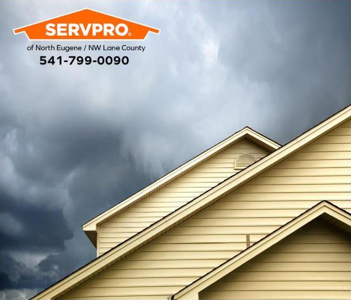 Powerful storm clouds fill the sky, racing towards a residence.